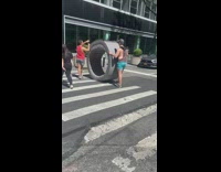 Two men roll round couch on street part 2