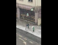 Starbucks barista spin snow fall street bus