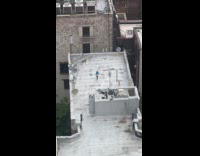 Person on building rooftop practice sword fighting