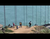 Two girls yellow birthday balloons red bridge