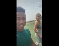 Green shirt guy girl run race grass