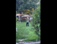 Guy plays VR headset shooting at yard