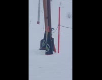 Guy skis with umbrella no ski poles