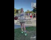 Girl throws football well in front of boys