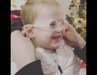 Baby girl wears glasses sees first time