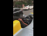 Man pink dress shirt gets out of exotic car with one seat. 