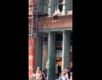 Man sit smoke on ledge look down