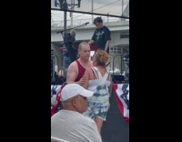 Couple dancing singing together affectionately at concert 