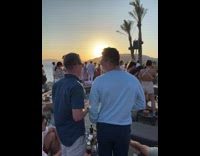 Girl chokes on shot at pretty outside bar