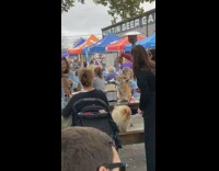 Cat on harness steals pizza slice