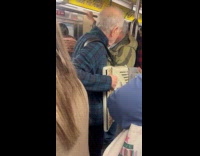 Man plays accordion riding on crowded subway