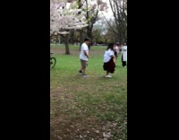 Man and woman tiktok dance at park