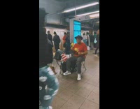 Man Busks at Subway Platform with Maracas