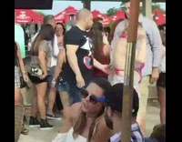 Pink bathing suit lady walks around beach 