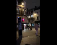 Man hangs onto swinging gate 