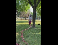 Guy walks on slackline boy hits rope