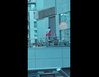 Woman on top of the table with England Football Flag on her back