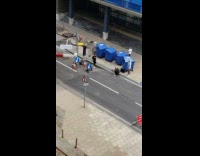 Man in black shirt poses near the construction site
