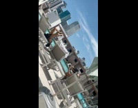 Collab IITW - Woman in black bikini stretching on the sunbed by the pool