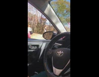 Two women photo shoot sidewalk forest car