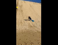 Man does sandboard downhill fell and roll