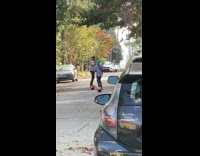 Guy play guitar ride one wheel skateboard