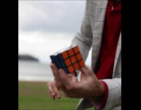 Guy solves rubiks cube in one move