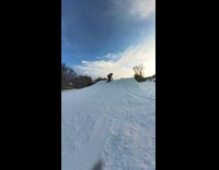 Kid jumps and falls down the snow slope 