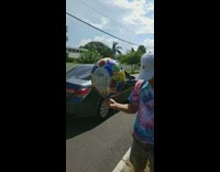 Guys standing in front of dead raccoon with get well soon balloon