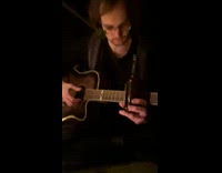 Man plays guitar with bottle of beer