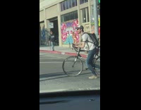Woman dances in front of pink mural 