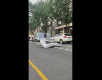 Man ride motorcycle drag large mattress street