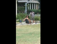 Black shirt girl poses by funeral home 