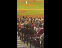 Two women black dress baseball stadium seats pictorial