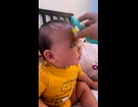 Baby with spinner toy on its forehead
