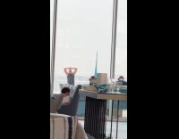 Man yoga stretches outside the building window