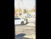 Guy watches black shirt girl dance sidewalk