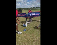 Little boys try to run through banner 