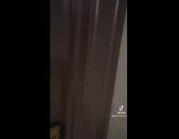 Girl suspicious about mirror in front of hotel bed 