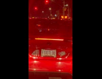 Red car with plate that reads FIXITLOU