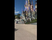 Woman pink dress spin face mask Disneyland