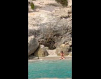 Woman in bikini with heels at beach