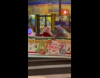 Santa Claus drive decorated convertible car waves