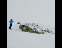 Red jacket guy backflips  skis over rock