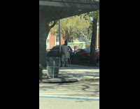 Guy sets tripod up on sidewalk 