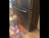 Little boy eats fruit snacks off floor
