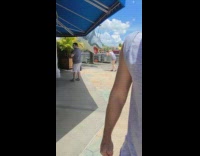 Striped overall shorts girl hanging shark sculpture 