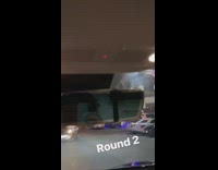 Woman takes pictures in front of Carls Jr fast foos store