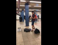 Man plays electric guitar at the subway