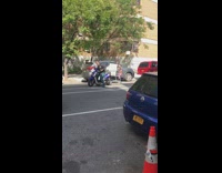 Guy blue scooter pulls full shopping cart